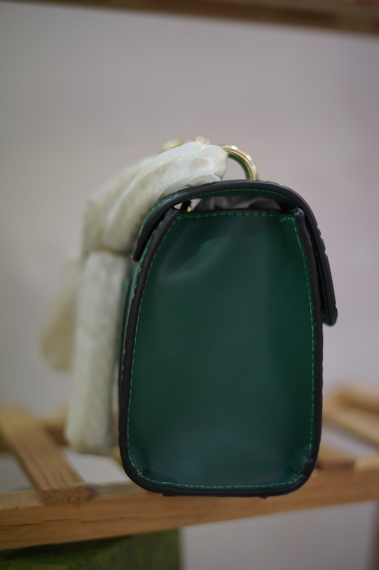 A4. Emerald Signature Lock Crossbody Bag