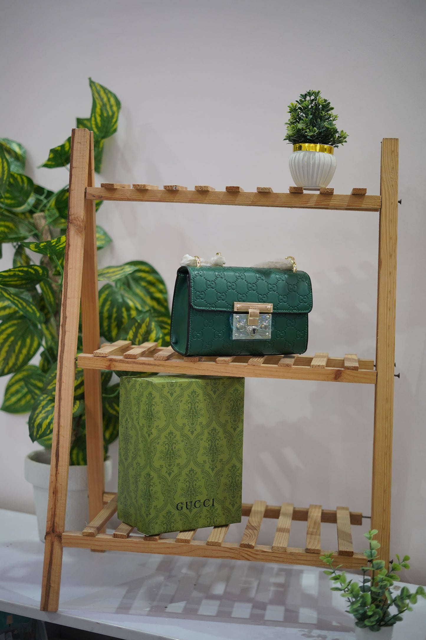 A4. Emerald Signature Lock Crossbody Bag