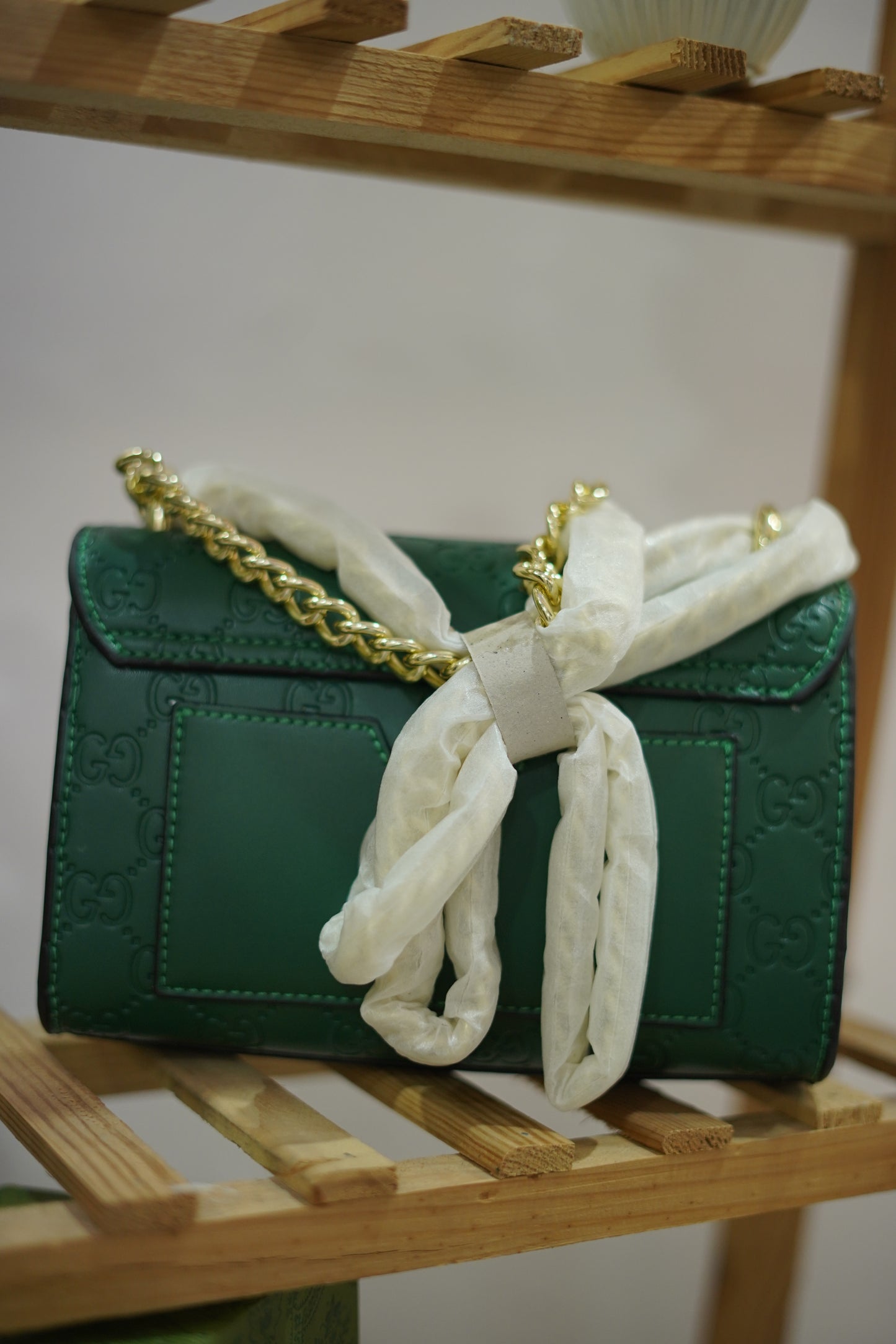 A4. Emerald Signature Lock Crossbody Bag