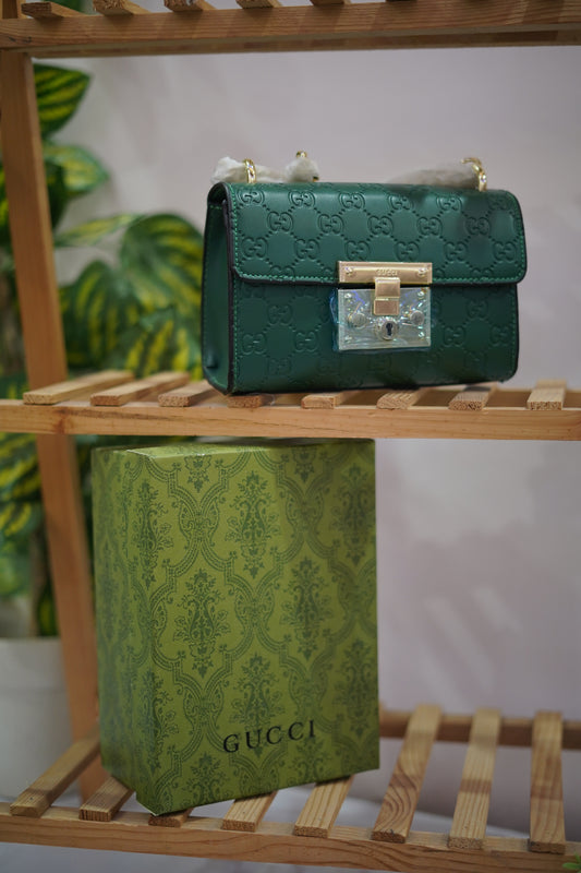 A4. Emerald Signature Lock Crossbody Bag