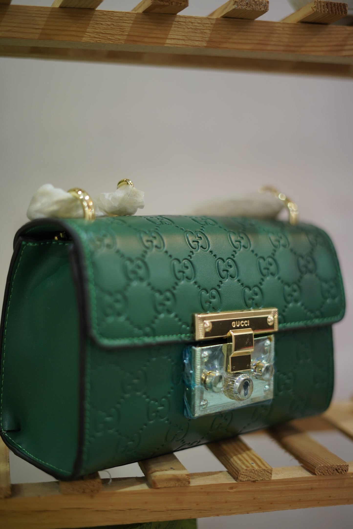 A4. Emerald Signature Lock Crossbody Bag