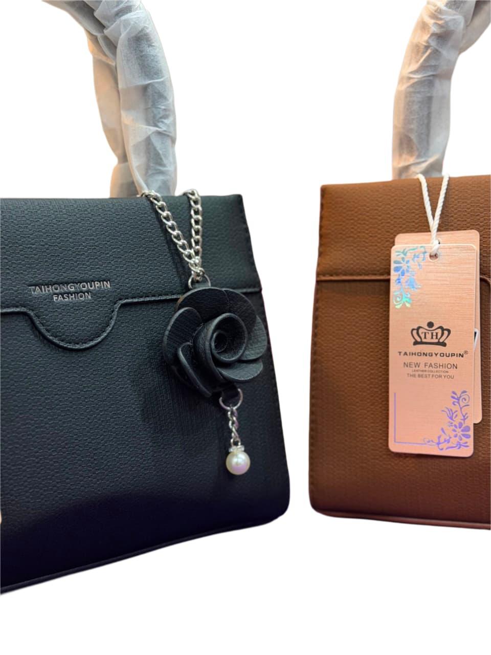 Elegant Black Top Handle Satchel Bag with Floral Charm